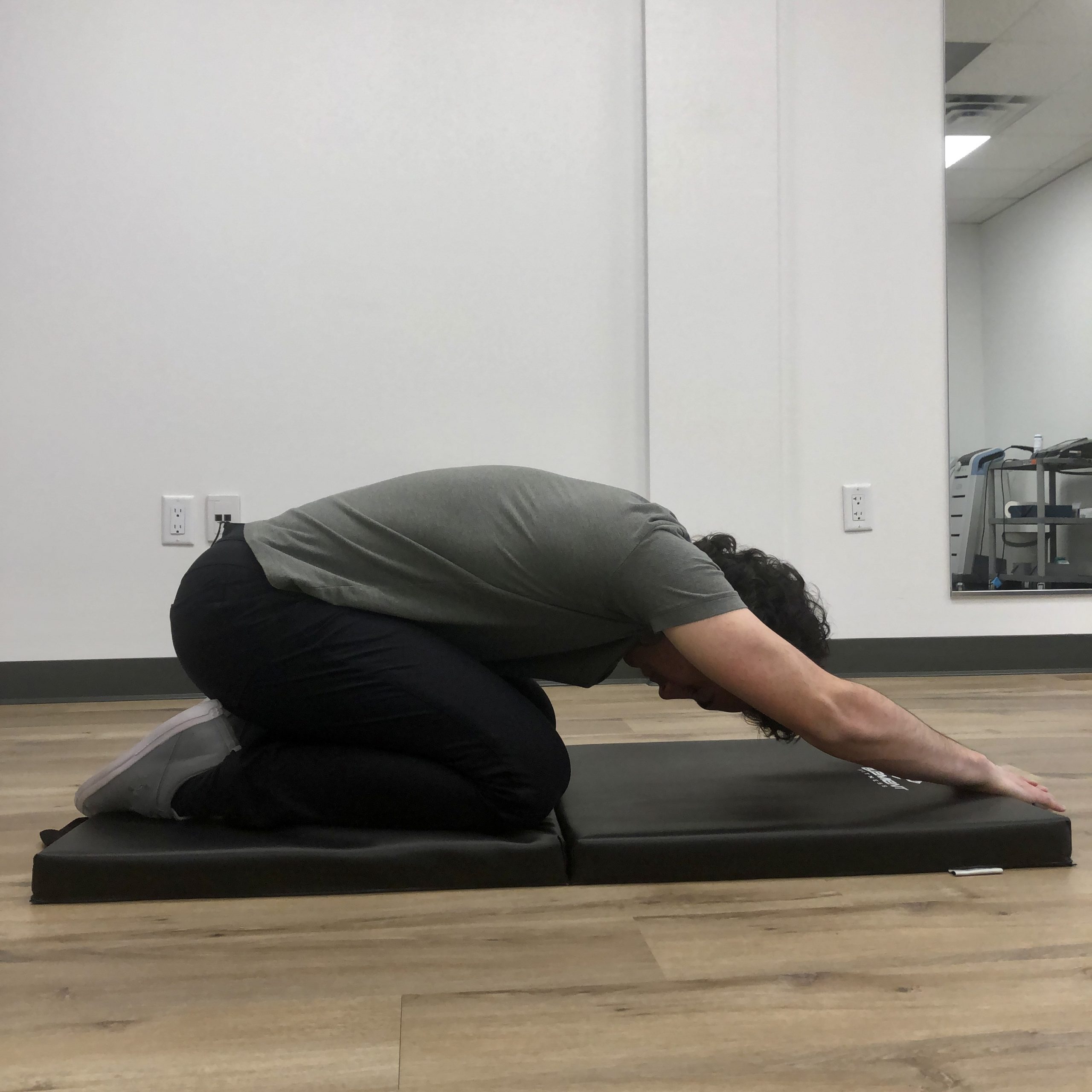 Child's pose performed in gym at First Line Physiotherapy North York